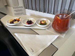 British Airways first class canapés and a red drink