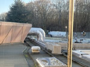 Hotel room view of a rooftop and venting ducts